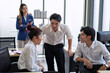 © Tongpool - Employees gossiping about female boss business man and woman whispering gossip office rumors