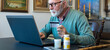 © Solid photos - Senior ill man buying pills online using credit card