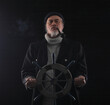 © serikbaib - ship captain at the steering wheel