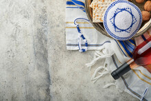 Passover Celebration Concept. Matzah, Red Kosher And Walnut. Traditional Ritual Jewish Bread Matzah, Kippah And Tallit On Old Concrete Background. Passover Food. Pesach Jewish Holiday.