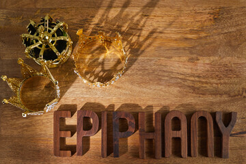 Poster - Happy Epiphany day. Three gold crowns on wooden background, symbol of Tres Reyes Magos, Three Wise Men. 