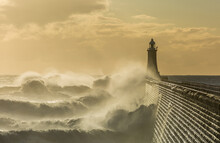 Big Waves Batter The Lighthouse & North Pier Guarding The Mouth Of The Tyne In Tynemouth At Sunrise, England
