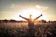 © kieferpix - young man in a field looking up to the sky with thumbs up, enjoys life and summer, nature, happiness positivity