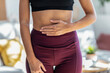 © nenetus - Sporty woman with her hands on her belly in front of the mirror.