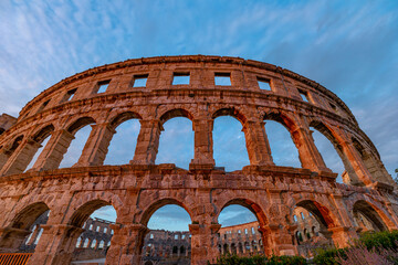 Wall Mural - Pula Amphitheater at sunset, also known as Coliseum of Pula, is a well-preserved Roman amphitheater in Pula, Istria, Croatia. Ancient arena built in 27 BC - 68 AD.