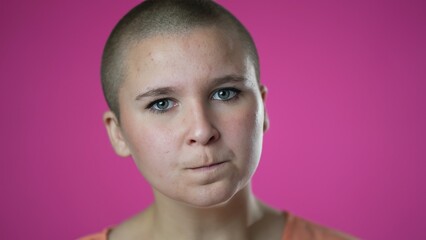 Portrait of angry frustrated despair upset portrait of gender fluid non binary young woman 20s closeup isolated on pink background