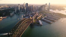 Aerial Drone Pullback Reverse View Of Sydney City And Sydney Harbour Above Sydney Harbour Bridge In The Late Afternoon  