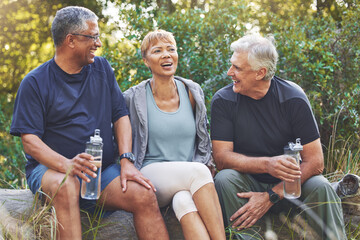 Wall Mural - Nature, fitness and senior friends in conversation while sitting in the forest after hiking. Happiness, communication and elderly people talking, bonding and drinking water after outdoor exercise.