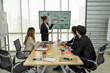 © Tongpool - Employee meeting big screen tv presentation conference discussion brainstorming and working together