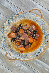 Canvas Print - Daub Provencal meat stew on plate on wooden background