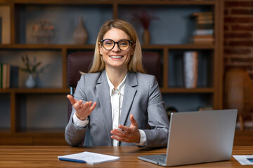 Smiling businesswoman looking at camera make conference business call, recording video blog, talking with client, distance job interview, e-coaching, online training concept, headshot portrait