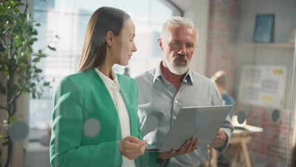 Leinwandbilder - Experienced Senior Engineer Consults Young Designer about a Project in a Creative Office. They Have a Discussion and Work on a Personal Computer to Improve User Experience on Company Website 