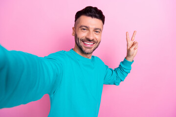 Poster - Selfie closeup portrait photo of attractive young handsome man brunet hair beard make shot show v-sign peace isolated on pink color background