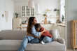 © DimaBerlin - Loving caring mother hugging teen daughter. Parent mom showing understanding and support to upset sad teenage girl. Crying child sharing feelings with mommy while sitting together at home