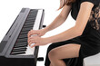 The pianist plays the piano. Pretty brunette