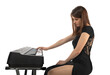 The pianist plays the piano. Pretty brunette