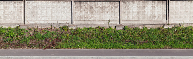 Gray industrial concrete fence on a roadside, background photo texture