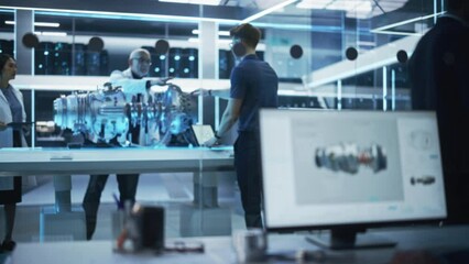 Fototapete - Middle Aged Engineer, Project Manager and Team of Scientists Collaborate on a New Type of Electric Turbine Engine. Rack Focus Moves to Industrial Designer Working in 3D CAD Software on Computer.
