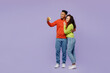 © ViDi Studio - Full body side view young couple two friends family man woman of African American ethnicity wear casual clothes doing selfie shot mobile cell phone together isolated on plain light purple background.