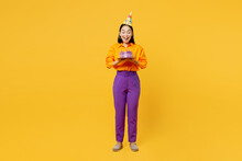 Full Body Happy Surprised Shocked Amazed Fun Young Woman Wears Casual Clothes Hat Celebrating Hold In Hand Cake With Candles Isolated On Plain Yellow Background. Birthday 8 14 Holiday Party Concept.