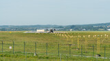 Fototapeta  - A plane taking off, positioned at the beginning of the runway