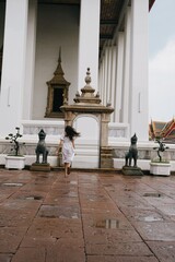 tourist girl at wat pho temple in bangkok, thailand