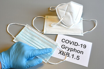 Covid-19 new variant. Doctor's hand in blue glove and writing 