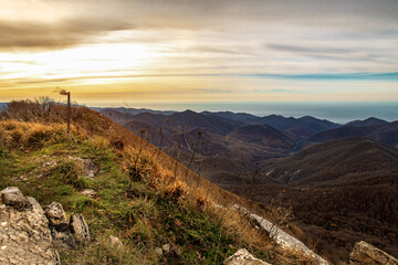 Wall Mural - View at dawn from the top of Mount Peus in the North-Western Caucasus. Stunning view from a height of 1000 m to the mountain peaks of the Black Sea coast of the Caucasus.