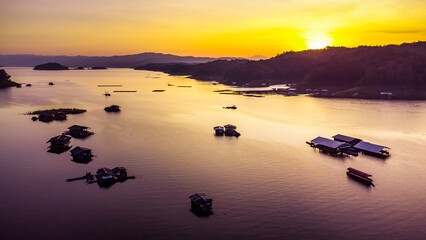 Wall Mural - Aerial view of landscape sunset with Reservoir and raft house Thailand