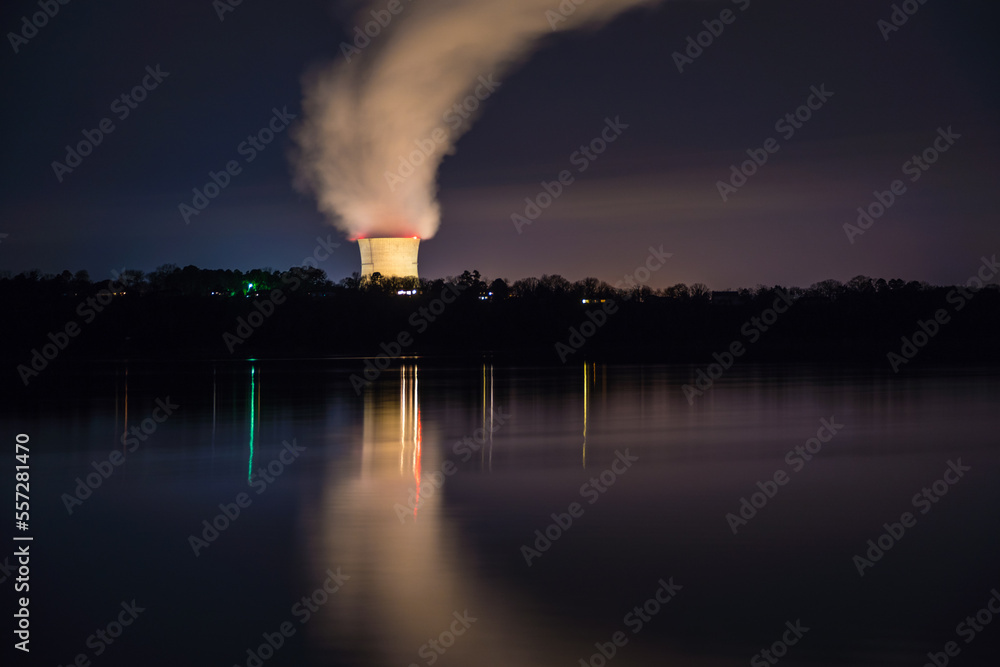 Night view of a pressurized water nuclear power plant located with ...