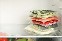 Vacuum Bags With Different Vegetables In Fridge, Space For Text. Food Storage