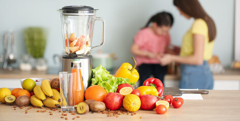 Wall Mural - Blender and ingredients for tasty smoothie on kitchen table