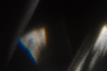 rainbow light effect from sun flares on black background, colorful glare and shine, light rays on sp