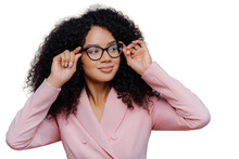 Headshot Of Attentive Female Boss Keeps Hands On Frame Of Glasses, Looks Pensively Away, Wears Rosy Formal Suit, Has Curly Afro Hairstyle, Poses Against Purple Background. People, Business, Ethnicty