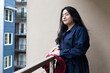 © annie - Asian American trans woman standing outside.