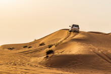 Shot Of A SUV On A Sand Dune. Outdoors