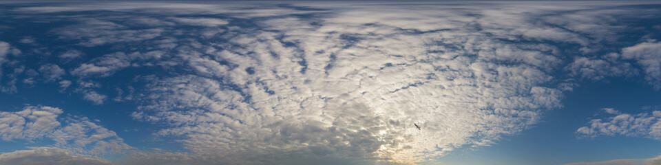 Wall Mural - panorama of a dark blue sunset sky with golden cumulus clouds. seamless hdr 360 panorama in spherica