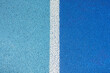 part of the athletic field with a vertical white line. top view. Texture of color rubber floor on playground