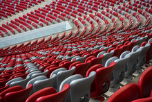 Rows Of Empty White And Red Chairs In A Football Stadium. Anticipation Of An Upcoming Sporting Or Cultural Event.