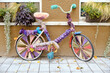 Vintage colorful bicycle with knitted decoration on the street