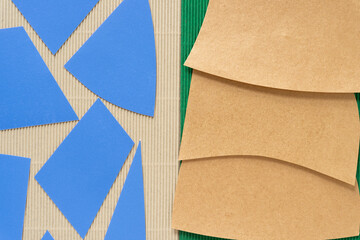 Canvas Print - cut blue and gold paper shapes on beige and green corrugated texture