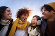 © CarlosBarquero - Close up of Multi-ethnic group of happy friends hugging and having fun Isolated young smiling people laughing togethers enjoy the community Cheerful face of mixed race young students in winter clothes