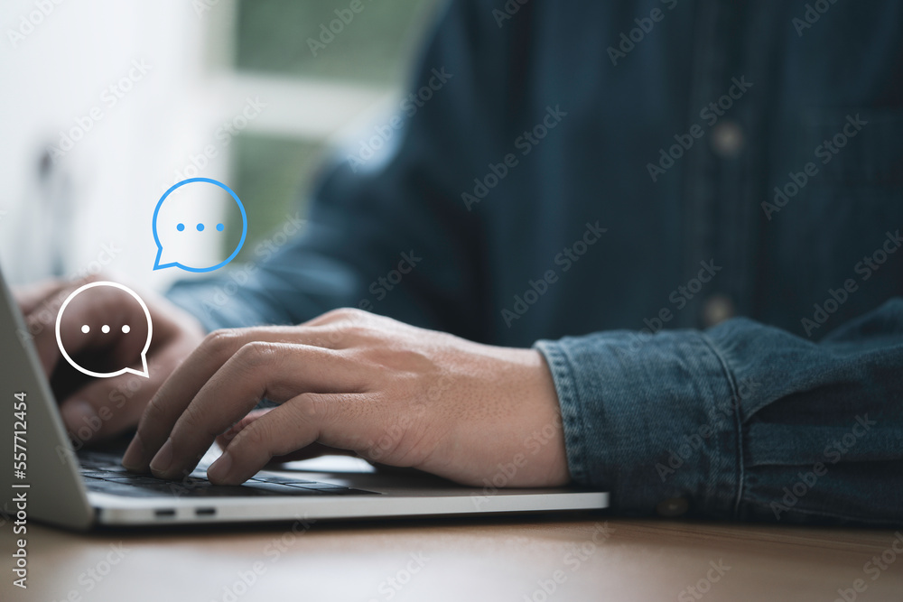 Businessman using computer laptop typing to send message to colleague , Communication by chat and social network technology concept.