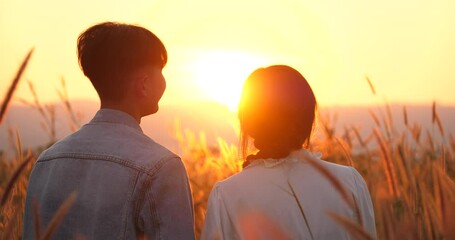 Wall Mural - Couple enjoying beautiful landscape during sunrise or sunset, couple with nature, valentine concept