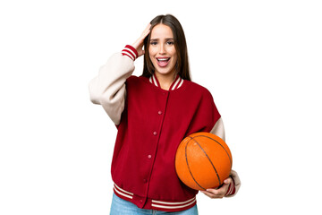 Young beautiful woman playing basketball over isolated chroma key background with surprise expression