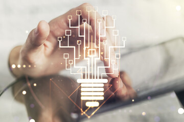 Wall Mural - double exposure of creative light bulb hologram with chip and finger clicks on a digital tablet on b