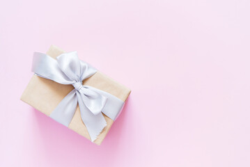 Poster - Rectangular gift box with silver ribbon on plain light pink background