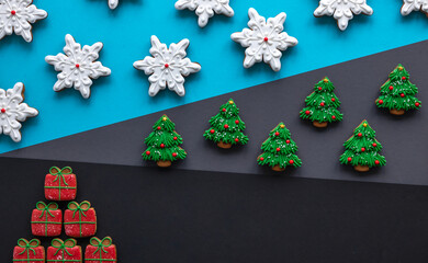 Wall Mural - Christmas gingerbread covered with icing on a colored background, flat lay.