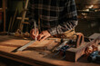 © ADDICTIVE STOCK - Crop woodworker measuring wooden board in workshop