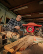 © ADDICTIVE STOCK - Carpenter cutting wood on circular saw table